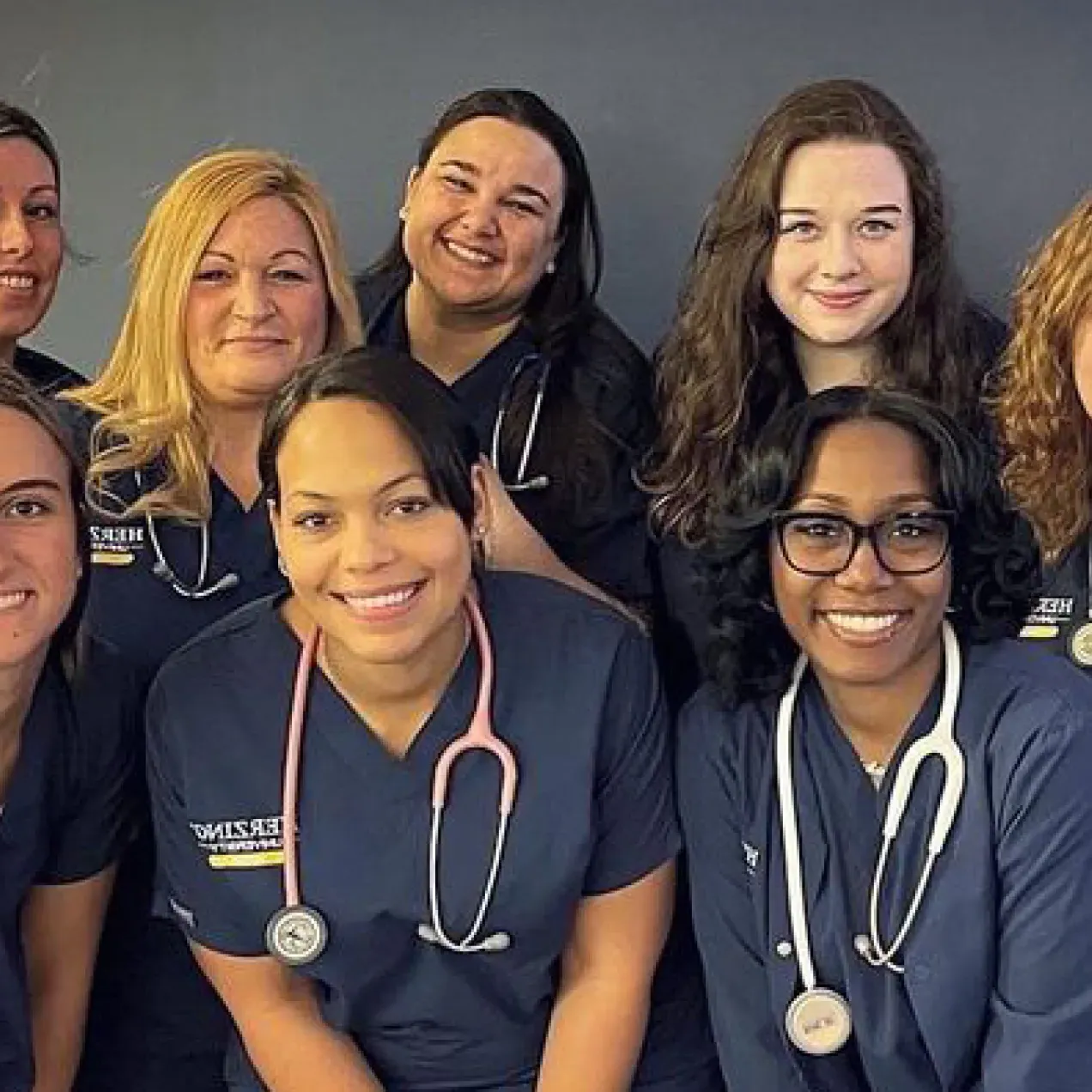 Group of Nursing Students in Scrubs Smiling